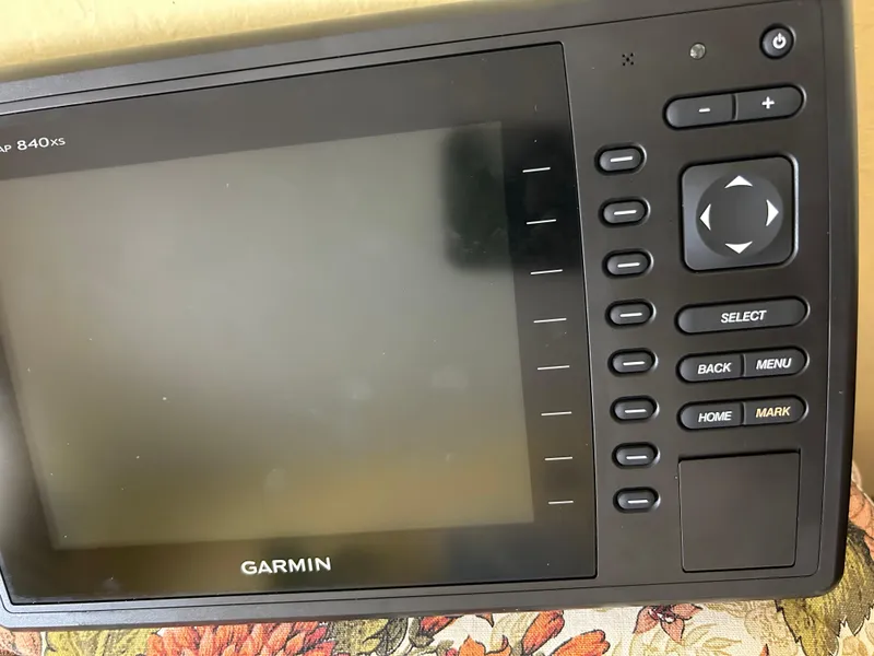 Slide: The Image of Garmin GPS device on a 1989 Bayliner 3288 boat, featuring navigation controls. - 10