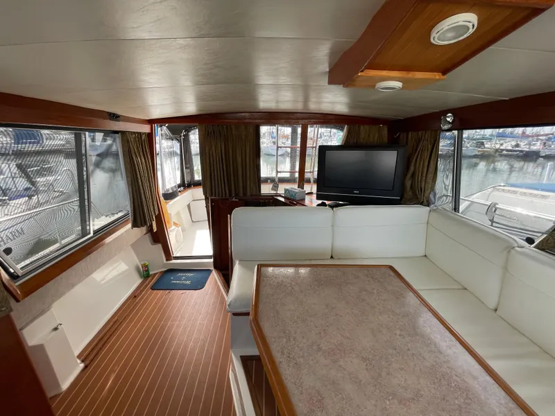 Slide: The Image of Interior of a 1989 Bayliner 3288 yacht with seating and a TV. - 21