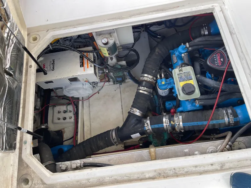 Slide: The Image of Engine compartment of a 1989 Bayliner 3288 boat, showcasing mechanical components and wiring. - 26