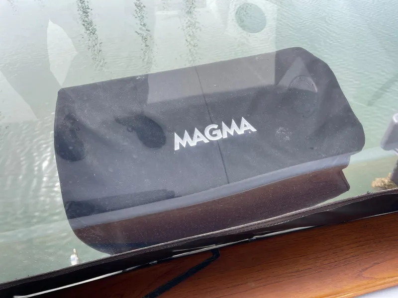 Slide: The Image of Magma grill on 1989 Bayliner 3288 boat deck, reflecting water surface. - 29