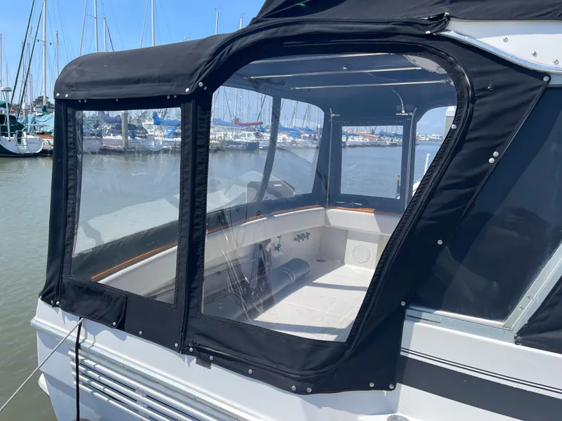 Slide: The Image of 1989 Bayliner 3288 boat with enclosed cockpit, docked at marina. - 3