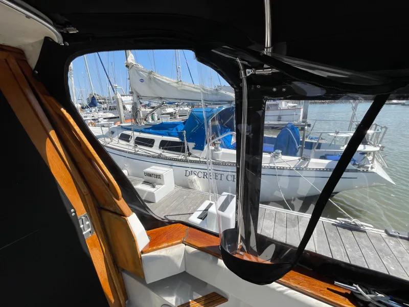 Slide: The Image of 1989 Bayliner 3288 interior view with marina and sailboats in background. - 4