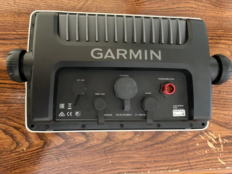Slide: The Image of Garmin marine device on wooden surface, compatible with 1989 Bayliner 3288 model. - 9