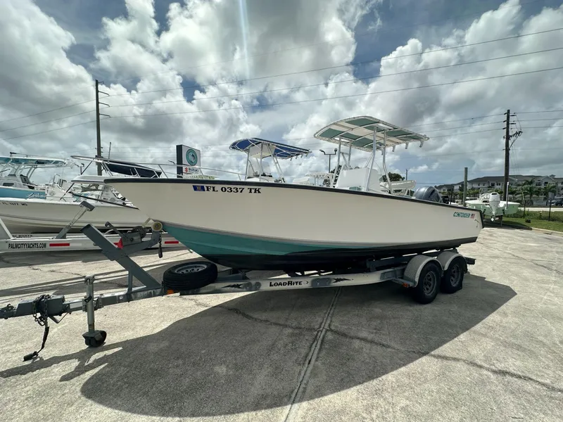 Slide: The Image of 2007 Contender 21 Open boat on trailer under cloudy sky. - 1