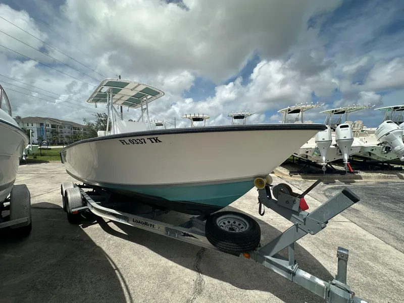 Slide: The Image of 2007 Contender 21 Open boat on trailer under cloudy sky. - 2
