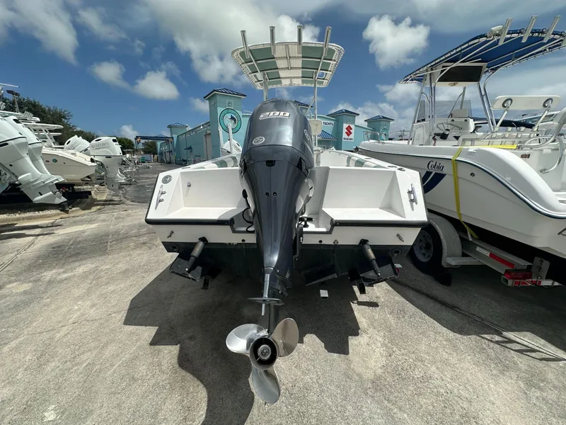 Slide: The Image of 2007 Contender 21 Open boat with outboard motor in a marina setting. - 3