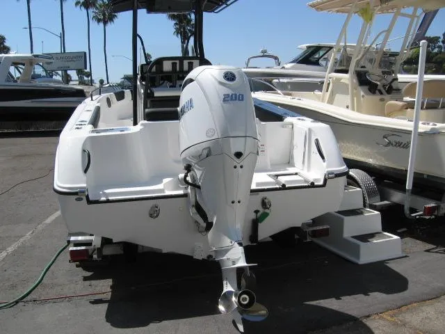 Slide: The Image of 2025 Edgewater 208 WATCHMAN CC boat with Yamaha 200 outboard motor, docked in marina. - 11