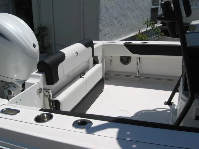 Slide: The Image of 2025 Edgewater 208 WATCHMAN CC boat interior with seating and motor. - 3