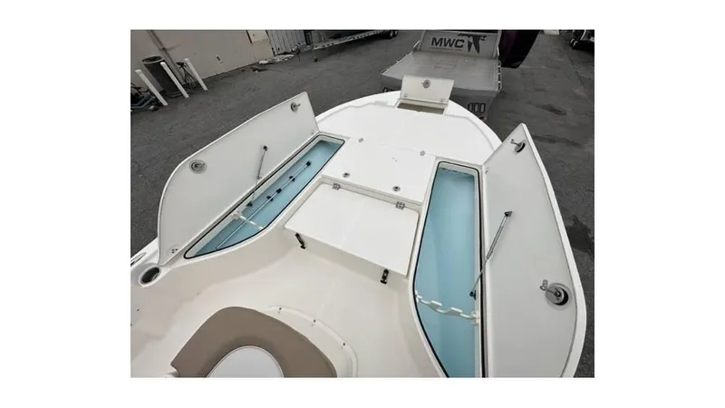 Slide: The Image of 2024 Sea Born FX22 Bay boat with open storage compartments. - 11