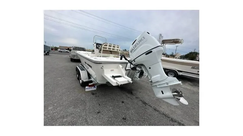 Slide: The Image of 2024 Sea Born FX22 Bay boat with outboard motor on trailer. - 15