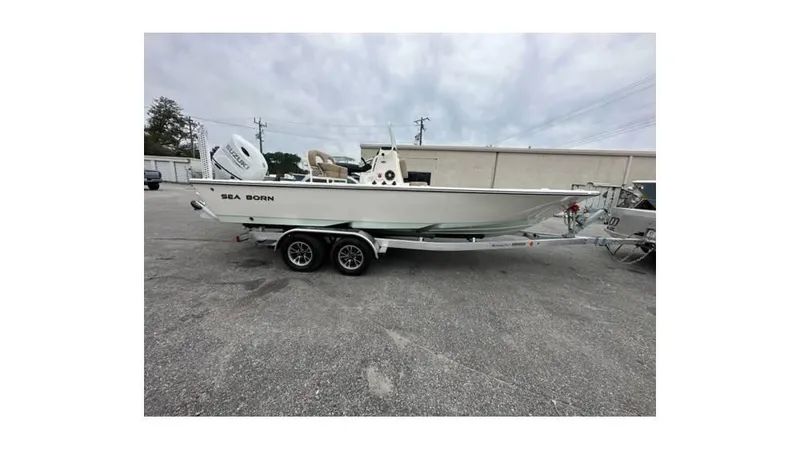 Slide: The Image of 2024 Sea Born FX22 Bay boat on trailer in parking lot. - 3