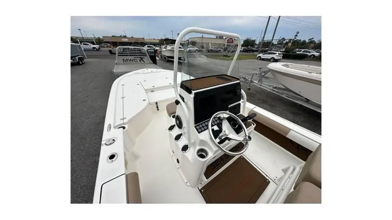 Slide: The Image of 2024 Sea Born FX22 Bay boat interior with steering console and seating. - 6