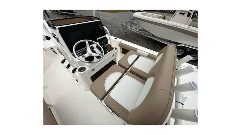 Slide: The Image of 2024 Sea Born FX22 Bay boat interior with steering console and seating. - 7