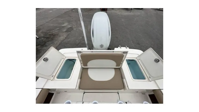Slide: The Image of 2024 Sea Born FX22 Bay boat with open storage compartments and seating. - 9