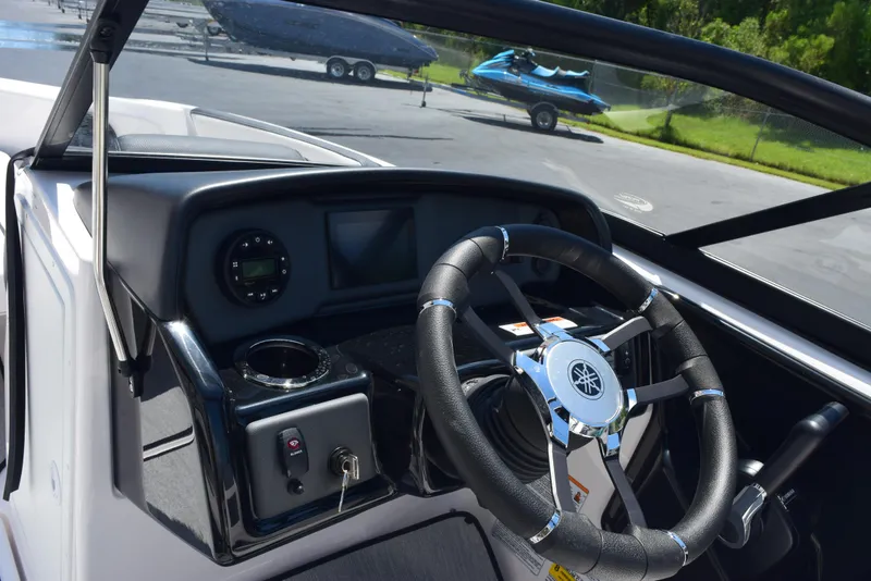 Slide: The Image of 2025 Yamaha AR195 boat dashboard with steering wheel and controls. - 14