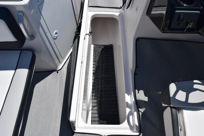 Slide: The Image of 2025 Yamaha Boats AR195 interior storage compartment with non-slip mat. - 16