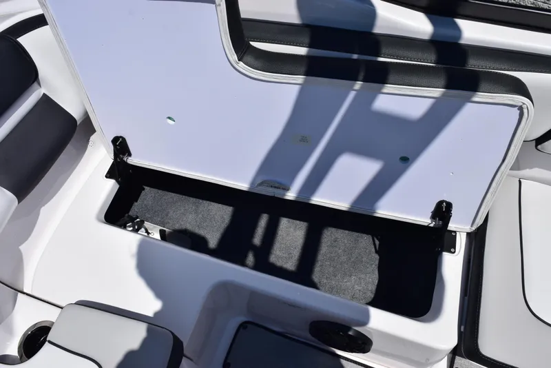 Slide: The Image of 2025 Yamaha AR195 boat storage compartment with open lid, showcasing interior space. - 19