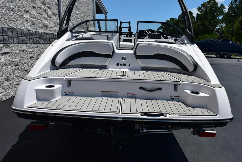 Slide: The Image of 2025 Yamaha Boats AR195, rear view, showcasing sleek design and spacious deck. - 4