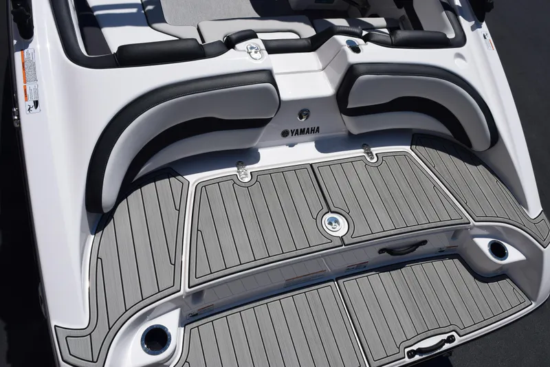 Slide: The Image of 2025 Yamaha Boats AR195 swim platform with cushioned seating and sleek design. - 7