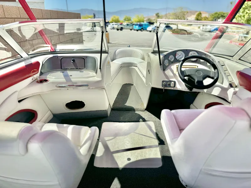 Slide: The Image of Interior of a 1998 VIP Vixen boat with white seating and dashboard. - 12