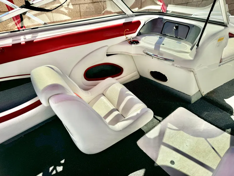 Slide: The Image of Interior of a 1998 VIP Vixen boat with white and red seating. - 13