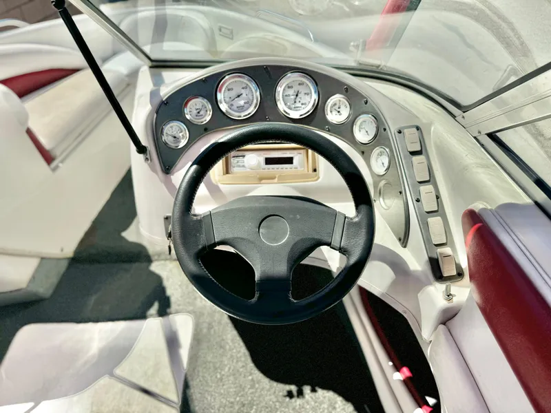 Slide: The Image of 1998 VIP Vixen boat dashboard with steering wheel and gauges. - 15
