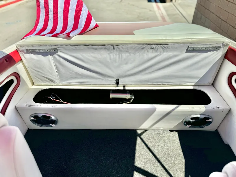 Slide: The Image of 1998 VIP Vixen boat interior with open storage compartment and American flag. - 19