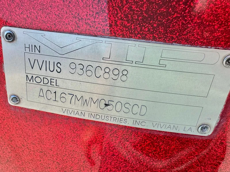 Slide: The Image of Metallic red VIP Vixen 1998 nameplate with HIN and model details. - 22