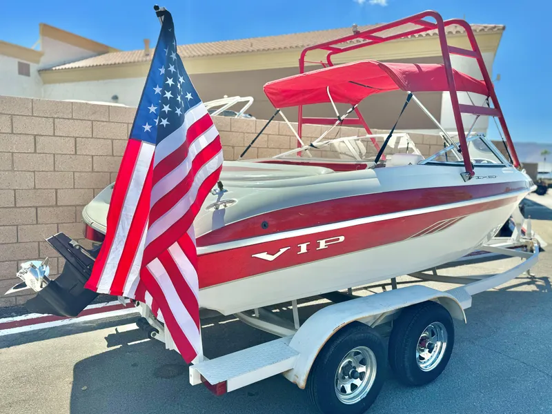 Slide: The Image of Red and white 1998 VIP Vixen boat on trailer with American flag. - 6