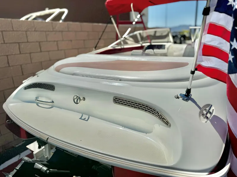 Slide: The Image of 1998 VIP Vixen boat with American flag, red canopy, and sleek white design. - 7