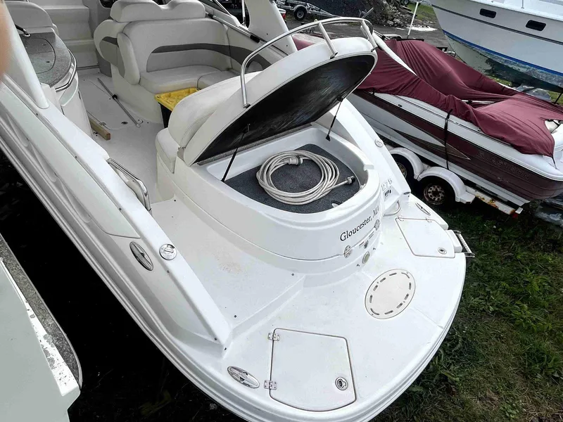 Slide: The Image of 2007 Chaparral 275 SSi boat with open storage compartment, docked on grass. - 13