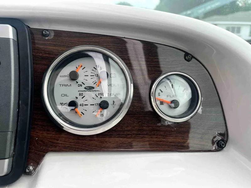 Slide: The Image of Dashboard gauges of 2007 Chaparral 275 SSi boat, featuring trim and fuel indicators. - 19