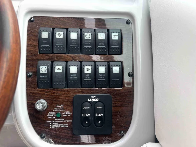 Slide: The Image of Control panel of a 2007 Chaparral 275 SSi boat with switches and Lenco trim tab controls. - 23