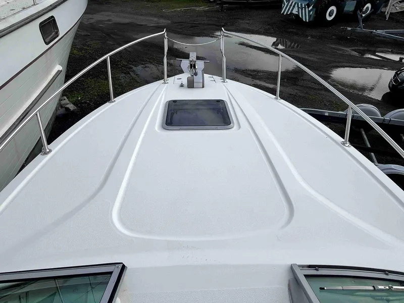Slide: The Image of 2007 Chaparral 275 SSi boat deck with railing and hatch, docked on land. - 27