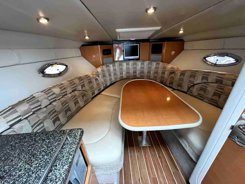Slide: The Image of 2007 Chaparral 275 SSi boat interior with cozy seating and wooden table. - 32