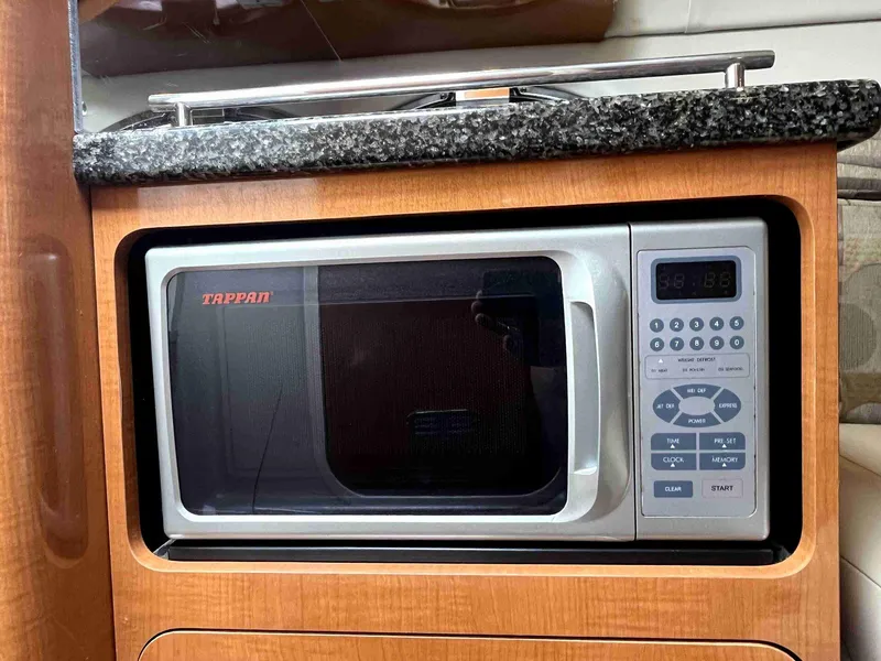 Slide: The Image of Microwave in 2007 Chaparral 275 SSi boat kitchen with wood cabinetry. - 37