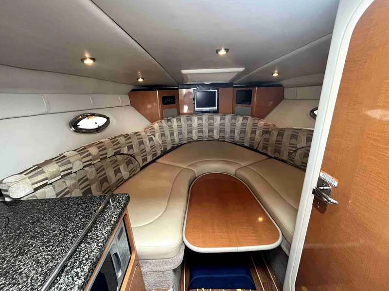 Slide: The Image of Interior of 2007 Chaparral 275 SSi boat with cozy seating and wooden table. - 38