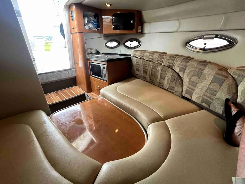 Slide: The Image of 2007 Chaparral 275 SSi cabin interior with seating, kitchenette, and portholes. - 39