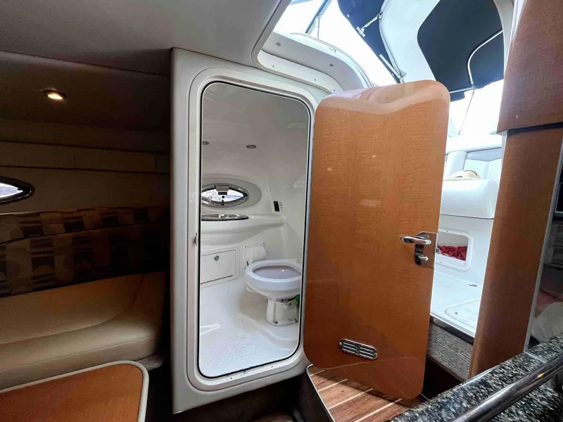 Slide: The Image of 2007 Chaparral 275 SSi boat interior with bathroom and seating area. - 42