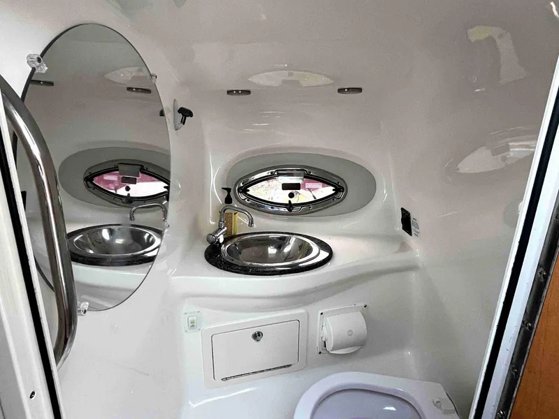 Slide: The Image of 2007 Chaparral 275 SSi boat bathroom with sink, mirror, and porthole window. - 43