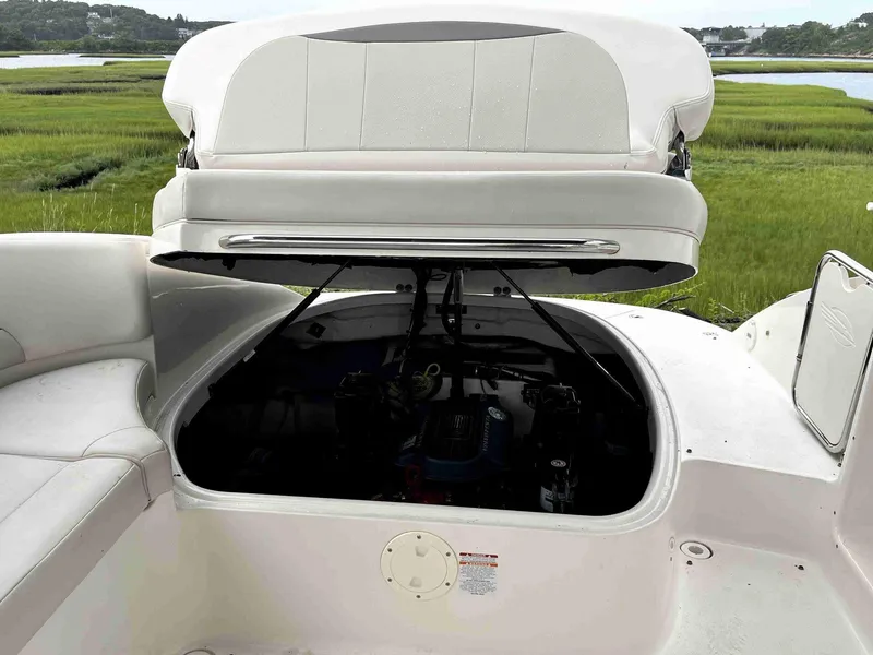 Slide: The Image of 2007 Chaparral 275 SSi boat with open engine compartment, white seating, scenic background. - 44
