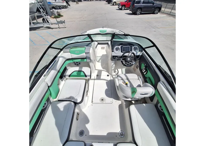 Slide: The Image of 2016 Chaparral Vector 203 boat interior with green accents and modern dashboard. - 10