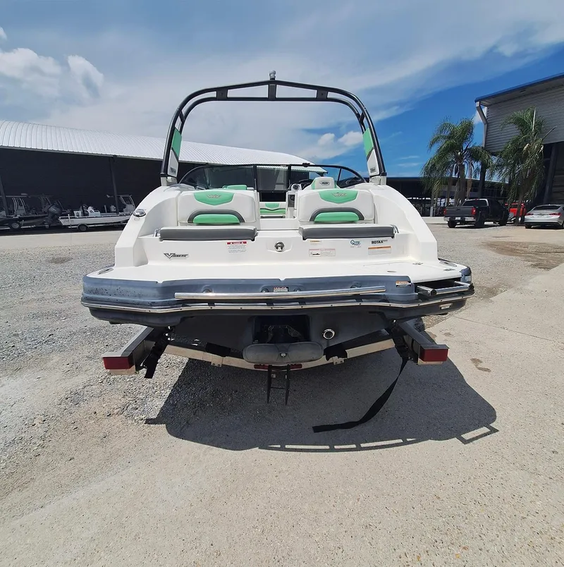 Slide: The Image of 2016 Chaparral Vector 203 boat, rear view, parked outdoors on a sunny day. - 12