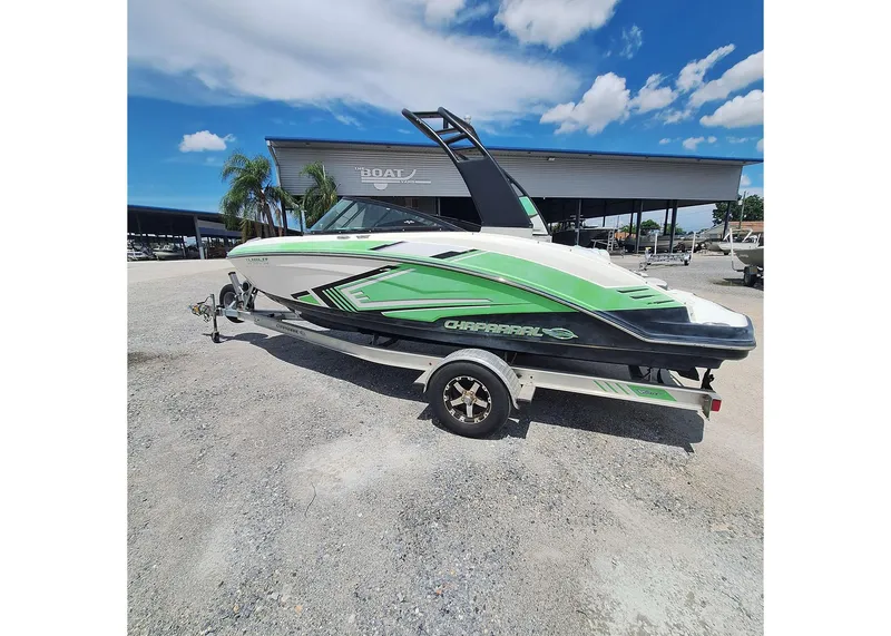 Slide: The Image of 2016 Chaparral Vector 203 boat with green accents on a trailer, parked outdoors. - 6