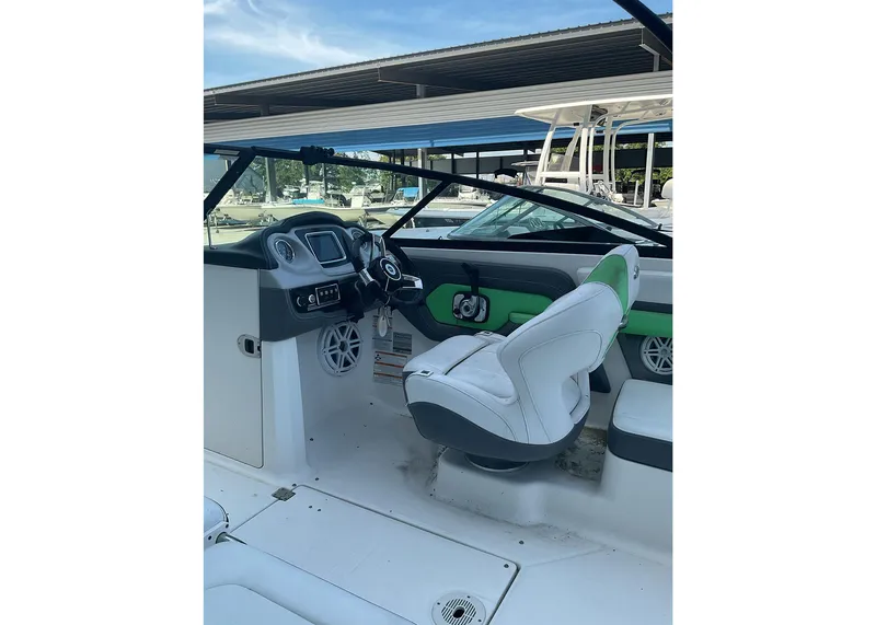 Slide: The Image of 2016 Chaparral Vector 203 boat interior with steering wheel and seating. - 7