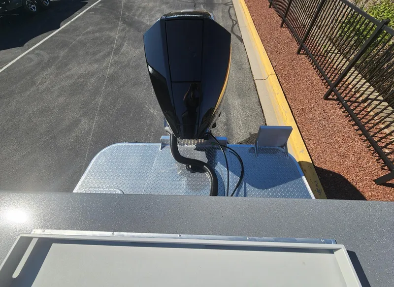 Slide: The Image of 2025 Spartan 200 Astoria rooftop view with mounted equipment, parked on asphalt near a fence. - 2