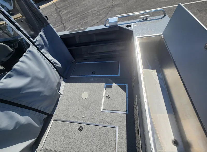 Slide: The Image of 2025 Spartan 200 Astoria boat interior with storage compartments and seating area. - 3