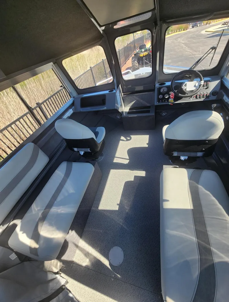 Slide: The Image of Interior of 2025 Spartan 200 Astoria boat with seating and control panel. - 5