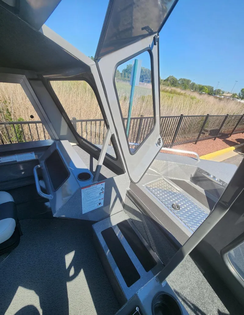 Slide: The Image of Interior view of 2025 Spartan 200 Astoria boat with open cabin and seating. - 6