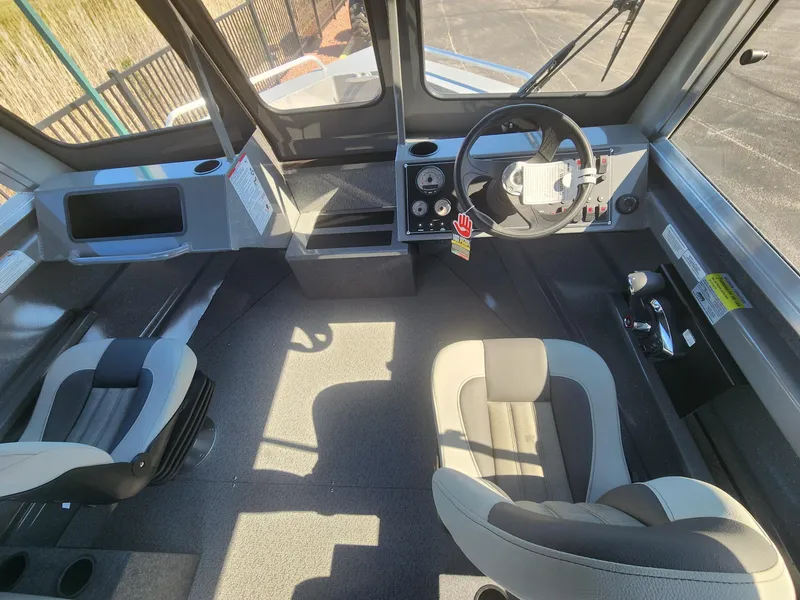 Slide: The Image of Interior of 2025 Spartan 200 Astoria boat with modern seating and control panel. - 8